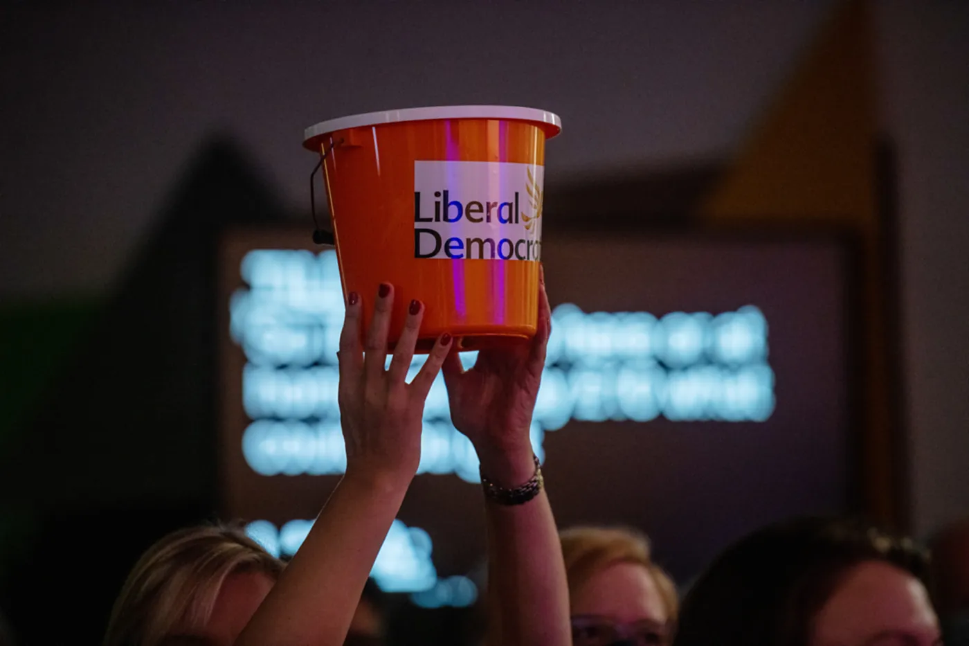 A Liberal Democrat supporter with a donation bucket at a party conference